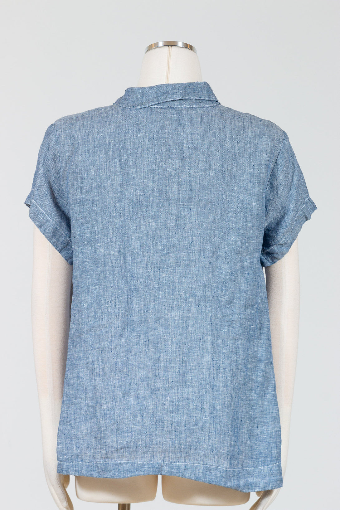 CP Shades Peek Top is a collared cap sleeve linen top, with a button placket with an A-line silhouette that skims the hips with a slightly curved hemline. 